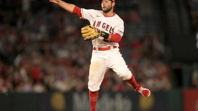 Jun 26, 2023; Anaheim, California, USA; Los Angeles Angels shortstop David Fletcher (22) throws Chicago White Sox center fielder Luis Robert Jr. (88) out at first in the eighth inning at Angel Stadium.